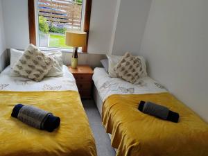 two beds sitting next to each other in a room at Westview in Buckie
