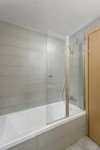a bathroom with a shower with a glass door at New Branch Gindi Tower 1BR with Parking in Tel Aviv