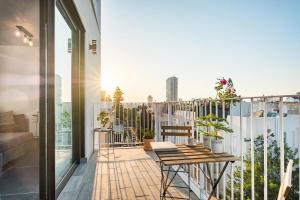 a balcony with a table and chairs and a view at Top Tlv in Tel Aviv