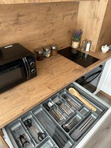 a kitchen with a stove top oven next to a counter at SkyTravel 26 Apartament Pileckiego Nowy Dwór Mazowiecki Airport Modlin 24H in Nowy Dwór Mazowiecki