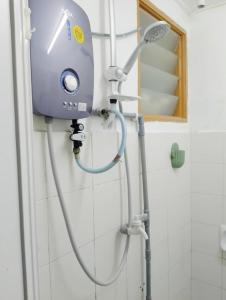 a shower head on the wall of a bathroom at The Loft Bentong in Bentong