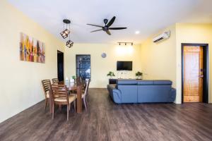 a living room with a blue couch and a table at R S Home in Tawau