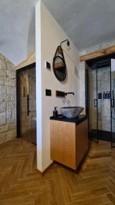 a bathroom with a sink and a mirror on the wall at 9CENTO B&B and Private SPA in Montenero Val Cocchiara