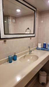 a bathroom counter with a sink and a mirror at Caesarea - Suite Paradise - C113 - סוויט פרדייס - נאות גולף, קיסריה in H̱efẕi Bah