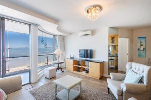 a living room with a view of the ocean at Hibernian Towers 309 Strand - Luxury Self Catering in Cape Town