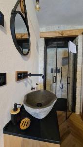 a bathroom with a sink and a mirror at 9CENTO B&B and Private SPA in Montenero Val Cocchiara