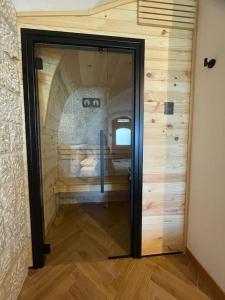 a room with a glass door in a room at 9CENTO B&B and Private SPA in Montenero Val Cocchiara