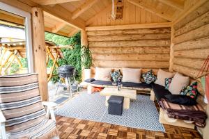 a living room of a log cabin with a couch at Ciukrowa Chatka z jacuzzi in Poronin