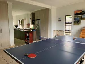 a ping pong table in the middle of a kitchen at Holiday home in George in George