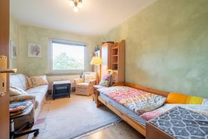 a living room with a bed and a couch at Private Apartment in Hannover