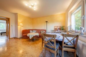 a living room with a table and a couch at Private Apartment in Hannover