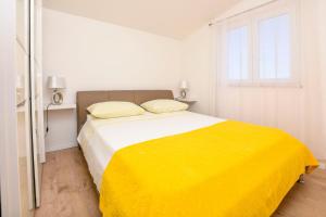 Ένα ή περισσότερα κρεβάτια σε δωμάτιο στο Apartments Branko