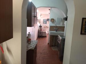 a kitchen with a hallway with a sink and a counter at Casetta Edera in Allerona