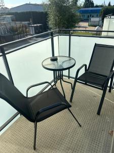 a table and two chairs sitting on a balcony at SkyTravel 27 Apartament Pileckiego Nowy Dwór Mazowiecki Airport Modlin 24H in Nowy Dwór Mazowiecki