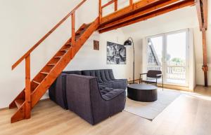 a living room with a couch and a staircase at Cosy apartment Antwerpen center2 in Antwerp