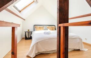 a white bedroom with a bed in a attic at Cosy apartment Antwerpen center2 in Antwerp