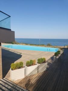 a swimming pool with the ocean in the background at апартаменты GREENWOOD in Odesa
