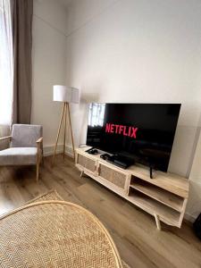 a living room with a flat screen tv on a entertainment center at City Apartment Messe Zentral PS4 Workspace in Frankfurt