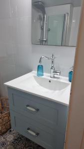 a bathroom with a white sink and a mirror at Suite paradise - E013 garden apartment in Caesarea