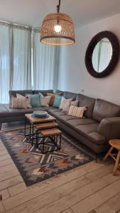 a living room with a couch and a table at Suite paradise - E013 garden apartment in Caesarea