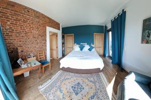 a bedroom with a bed and a brick wall at Gite avec piscine La Buissiere - Fernelmont in Pontillas +61 photos