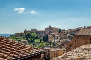 a view of a city from the roofs of buildings at Colours Studio 10 m away Piazza del Campo in Siena