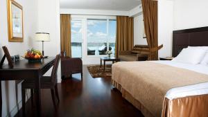a hotel room with a bed and a desk with a desk at Naantali Spa Hotel in Naantali