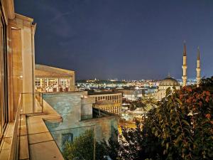 a view of a city at night with a mosque at Port Bosphorus in Istanbul