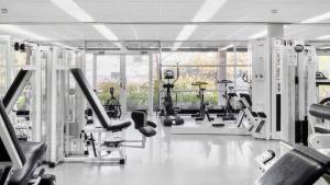 a gym with a lot of treadmills and machines at Ruissalo Spa Hotel in Turku