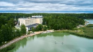 two boats in a large lake in front of a building at Ruissalo Spa Hotel in Turku
