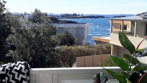 a balcony with a view of the water at Shutters by the Sea-Oceanfront-Sea views-Private retreat for 2 in Kiama