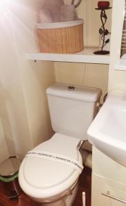 a bathroom with a white toilet and a sink at Nice & economic Studio in Baia Mare