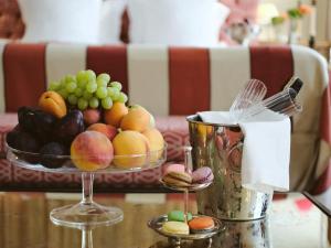 a bowl of fruit on a table with a bowl of grapes at Relais & Ch&acirc;teaux Stikliai Hotel in Vilnius