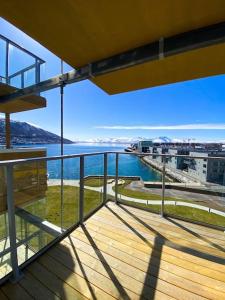 a balcony of a building with a view of the water at Lovely and exclusive northern lights apartment with excellent view. in Tromsø