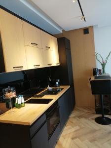 a kitchen with white cabinets and a counter top at Business Apartment Płock in Płock