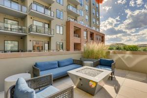 a patio with chairs and a couch on a building at Castle Rock Condo - Walk to Dining and Shopping! in Castle Rock