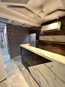 a kitchen with a marble counter top in a room at HOTEL KINGDOM in Gandhinagar