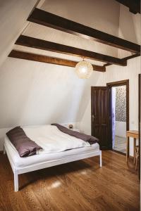 - une chambre avec un lit blanc et du parquet dans l'établissement MMexperience, à Bîrsana