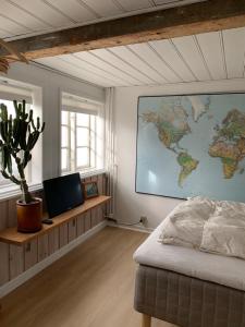 a bedroom with a map of the world on the wall at Timberframe house near Marstal Harbour in Marstal