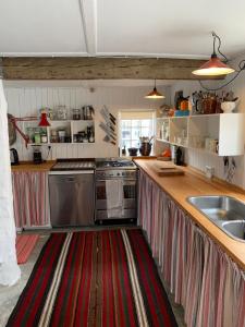 a kitchen with a red and white striped counter top at Timberframe house near Marstal Harbour in Marstal