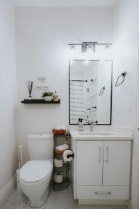 a white bathroom with a toilet and a sink at A Gentle Hideaway in the Urban Forest WEST END downtown Vancouver in Vancouver +55 photos