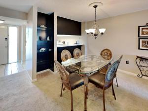 a dining room with a glass table and chairs at Emerald Isle fort Walton Beach 209 in Fort Walton Beach