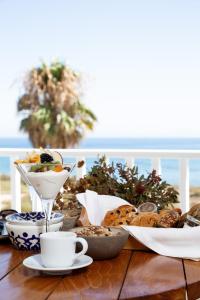 a table with a plate of food and cups of coffee at KAMEO, Antiparos in Antiparos