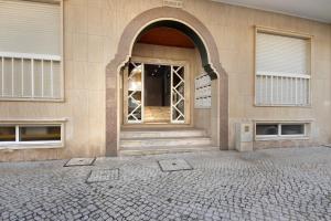 an entrance to a building with an open door at Live Vagueira Beach in Praia da Vagueira