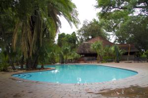 a swimming pool in the middle of a resort at Cresta Marang Gardens Hotel in Francistown