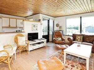 a living room with a couch and a table at 8 person holiday home in Struer in Humlum