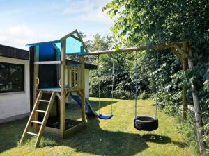 a playground with a swing and a bucket at 8 person holiday home in Struer in Humlum
