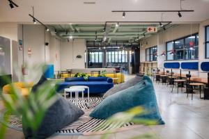a lobby with blue couches and tables and chairs at CampusKey Cape Town in Cape Town