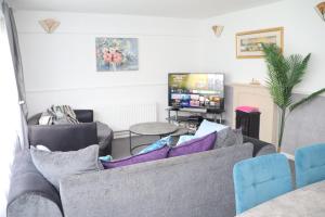 a living room with a couch and a tv at Superb 3 Bedroom flat in Stafford in Stafford