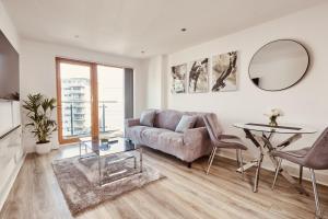 a living room with a couch and a table at Deluxe River Canal View & Free Secure Parking! in Leeds